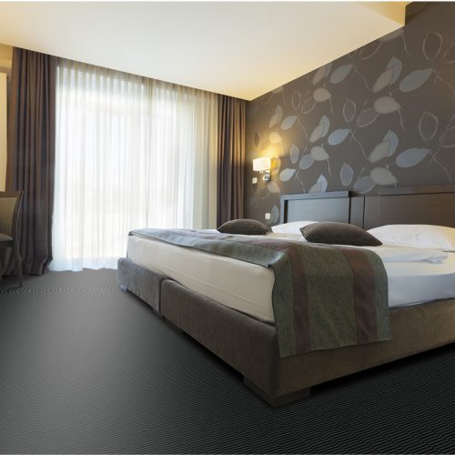 Moquette balsan anthracite en velours dans une chambre moderne.